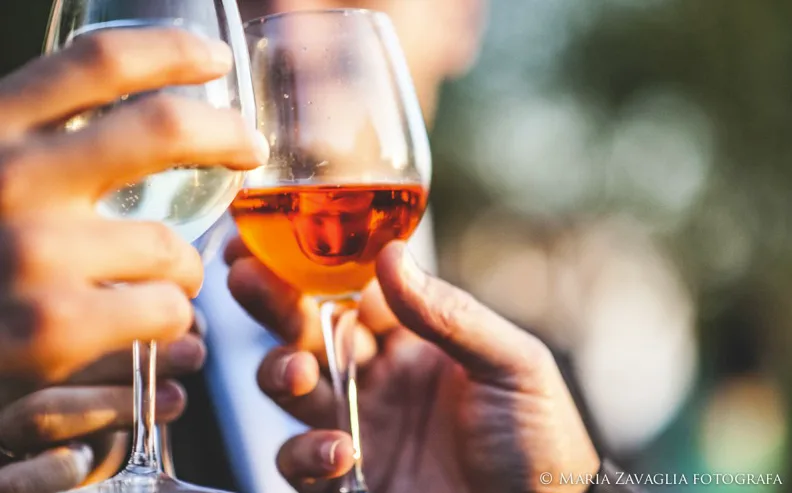 Brindisi ravvicinato con calici di vino bianco e rosato